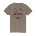 A taupe brown short-sleeve crewneck t-shirt featuring a dark brown graphic on the chest with a cowboy hat, rope border, and the text 'Let's RODEO' with three stars.
