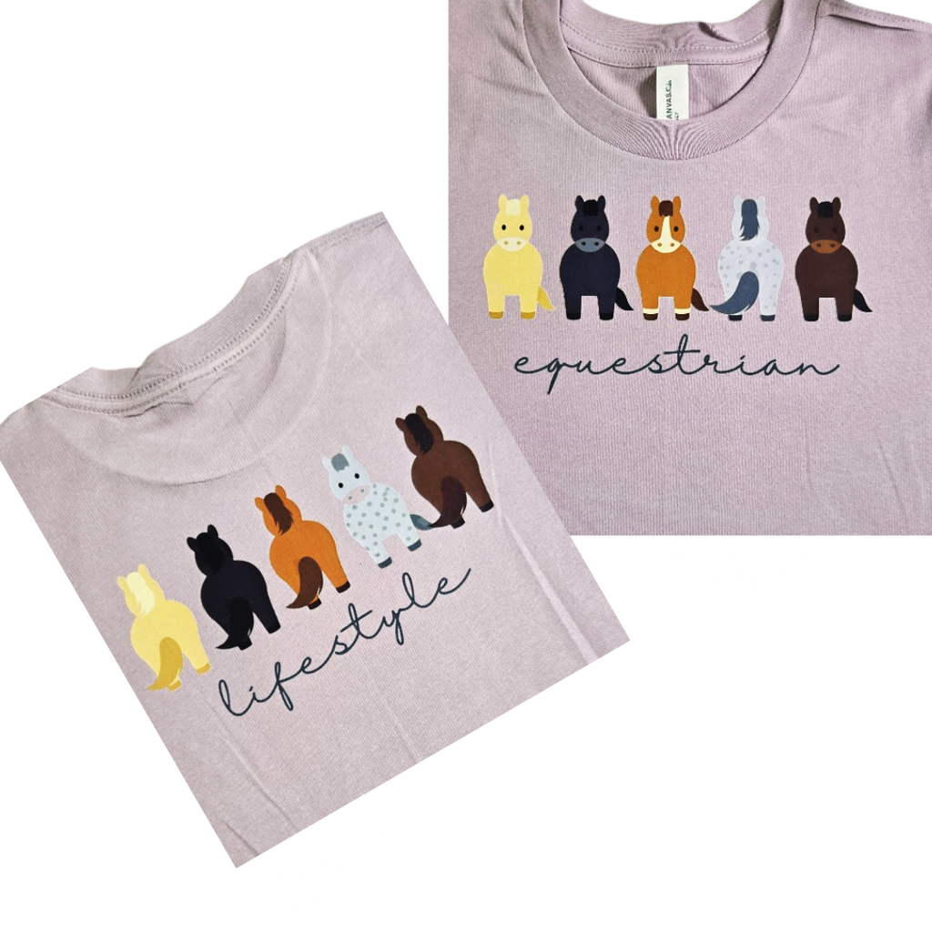 Two views of a light lavender crewneck t-shirt featuring a graphic of five stylized horses in different colors above the words 'equestrian' in script, with a second view showing 'lifestyle' in script.