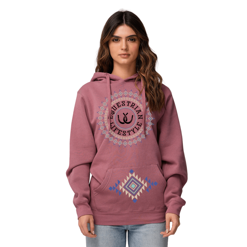 A woman modeling a dusty rose pink hoodie with a circular 'equestrian Lifestyle' graphic on the chest and a geometric diamond pattern on the front pocket, set against a plain white background.