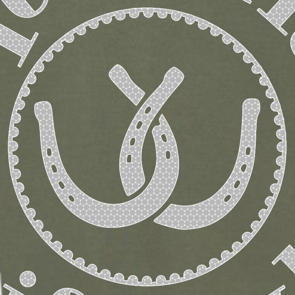 A close-up of a fabric pattern featuring a white horseshoe and interlocking loops motif inside a scalloped circular border on an olive green background.