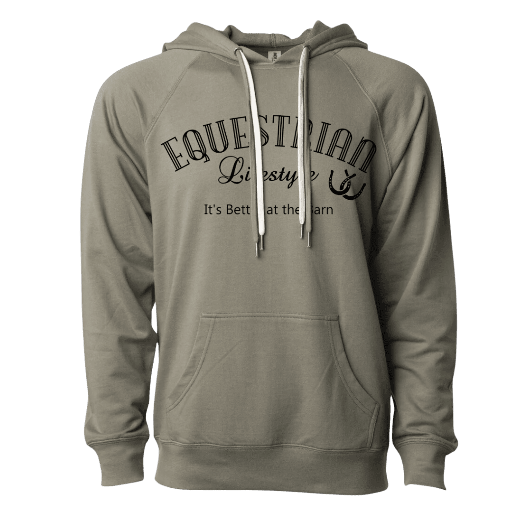 A sage green pullover hoodie with a black graphic print on the chest reading 'EQUESTRIAN Lifestyle' and 'It's Better at the Barn' with a horsehoer symbol. The hoodie features white drawstrings and a front kangaroo pocket, shown against a plain white background.