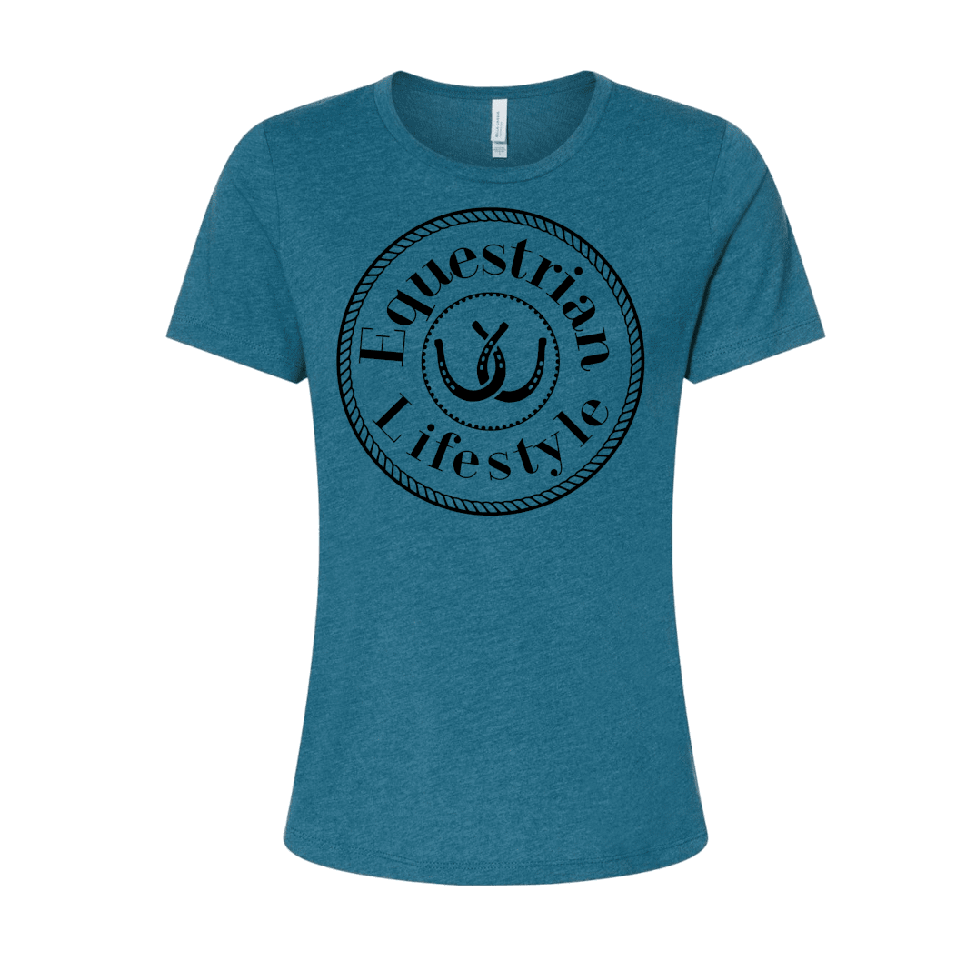 A women's short-sleeve crewneck t-shirt in heather teal blue, featuring a black circular graphic on the chest with the words 'Equestrian Lifestyle' and a horseshoe illustration.