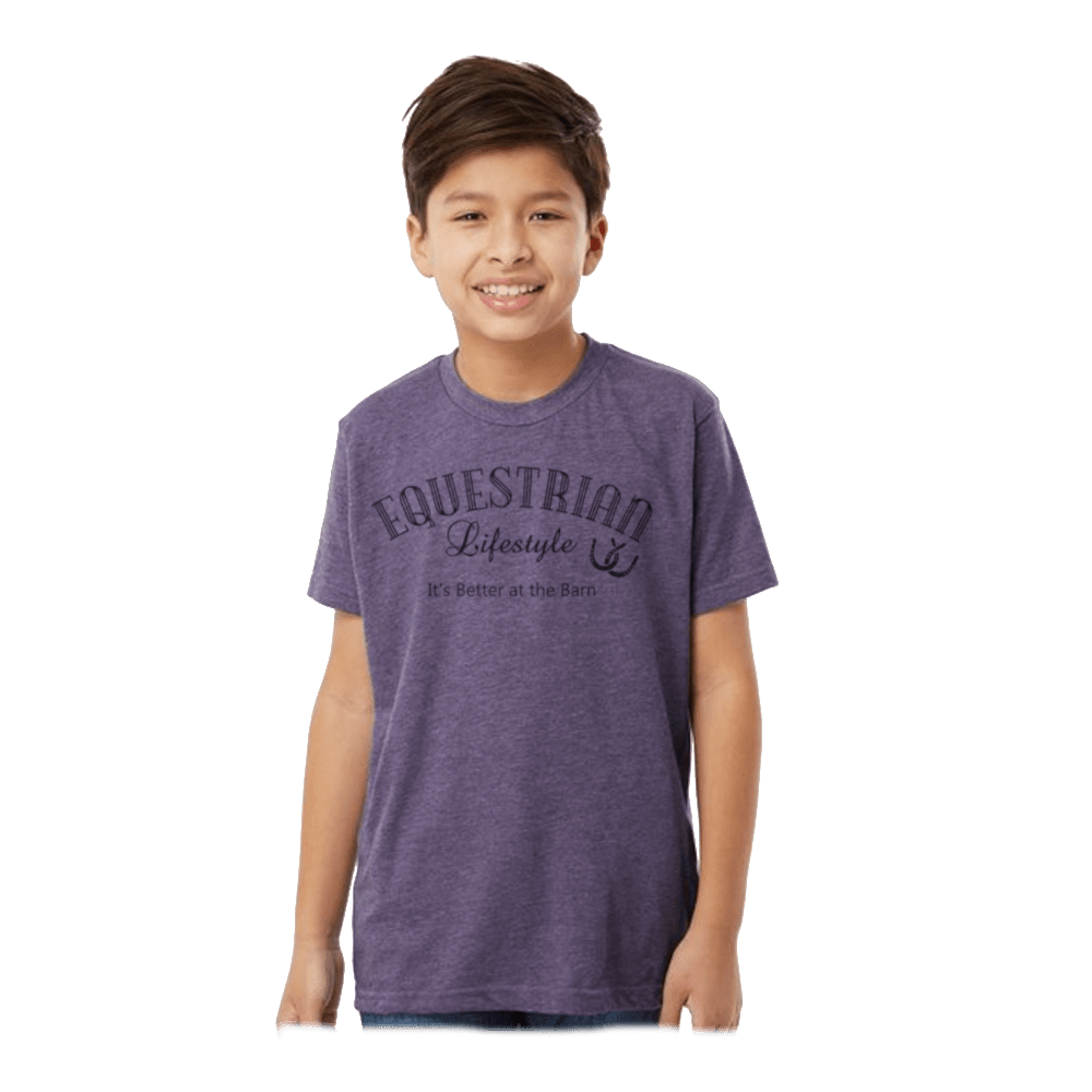 A smiling young boy wearing a heather purple t-shirt with a dark gray graphic that reads 'EQUESTRIAN Lifestyle' and 'It's Better at This Size!' on the front, set against a plain white background.
