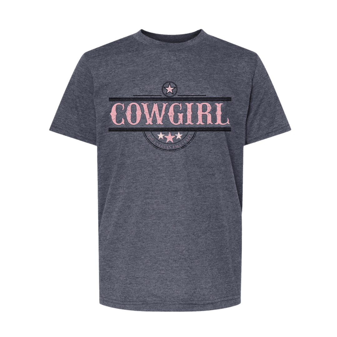 A dark heather gray t-shirt with a graphic on the chest featuring the word 'COWGIRL' in distressed pink letters, framed by black horizontal stripes and a circular emblem with stars.
