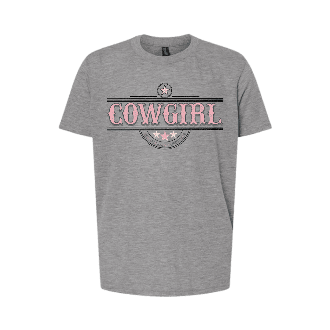 A heather gray short-sleeve t-shirt with a graphic on the chest featuring the word 'COWGIRL' in pink letters inside a distressed black and gray banner design with a star emblem above.