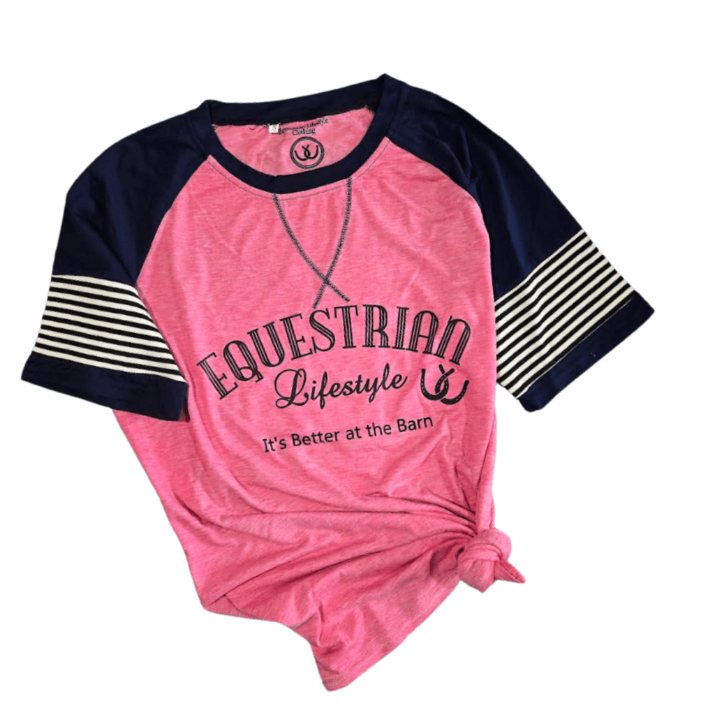 A women's raglan baseball t-shirt in pink and navy blue, featuring 'EQUESTRIAN Lifestyle' and 'It's Better at the Barn' printed on the front, with navy blue and cream striped sleeves, shown on a plain white background.