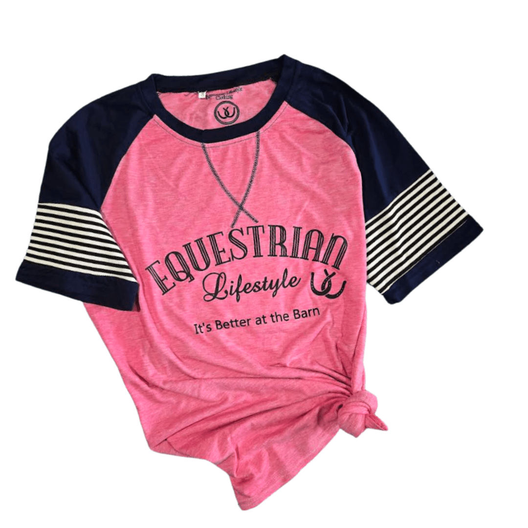 A women's raglan baseball t-shirt in pink and navy blue, featuring 'EQUESTRIAN Lifestyle' and 'It's Better at the Barn' printed on the front, with navy blue and cream striped sleeves, shown on a plain white background.